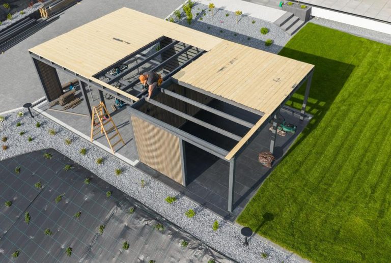 Backyard design company vs general contractor: Modern outdoor living structure under construction during a custom backyard renovation project